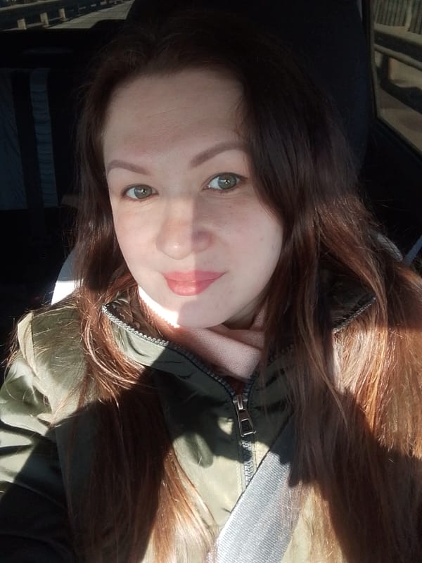 Woman in green jacket observed in car, Chaikovsky Russia