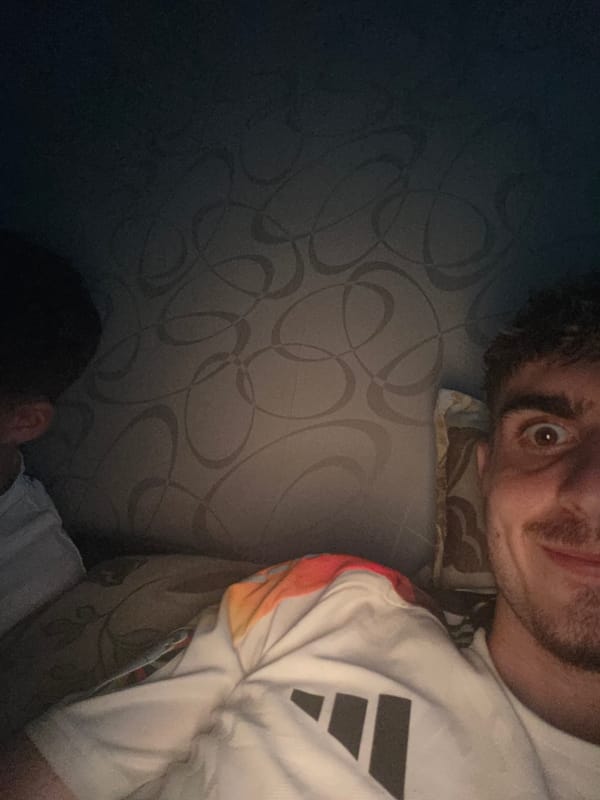 Two young men spend evening indoors in Voluyak, Bulgaria