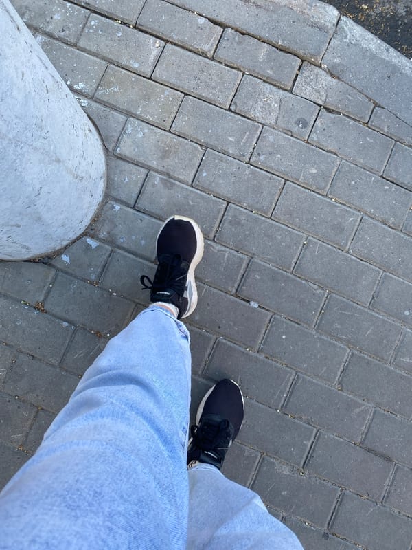 Standing on gray brick pavement in Novaya Usman
