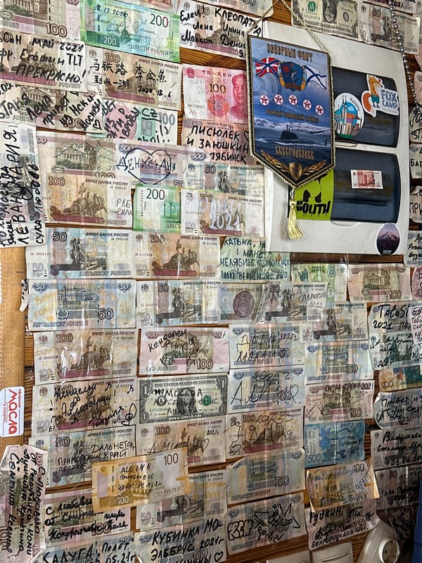 Bar wall in Terskol covered in signed banknotes from travelers