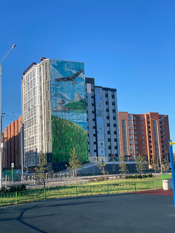 Multi-story buildings photographed under clear skies in Kokshetau