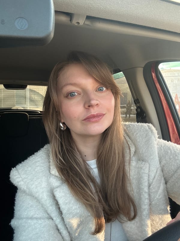 Woman takes selfies in car during sunny winter day