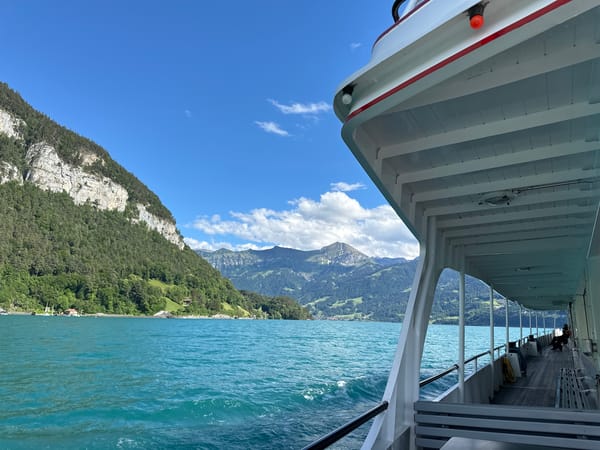 Ferry crosses turquoise Lake Thun near Merligen, Switzerland