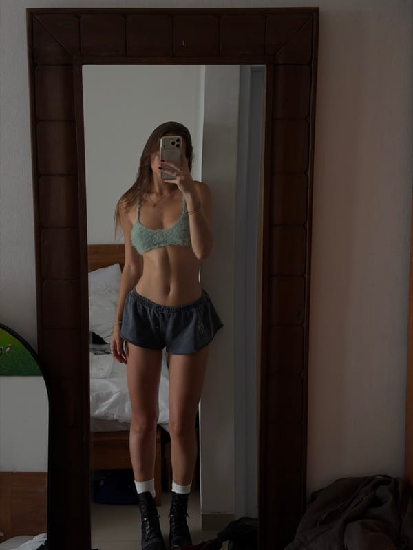 Woman Takes Mirror Selfie in Tibubeneng, Indonesia