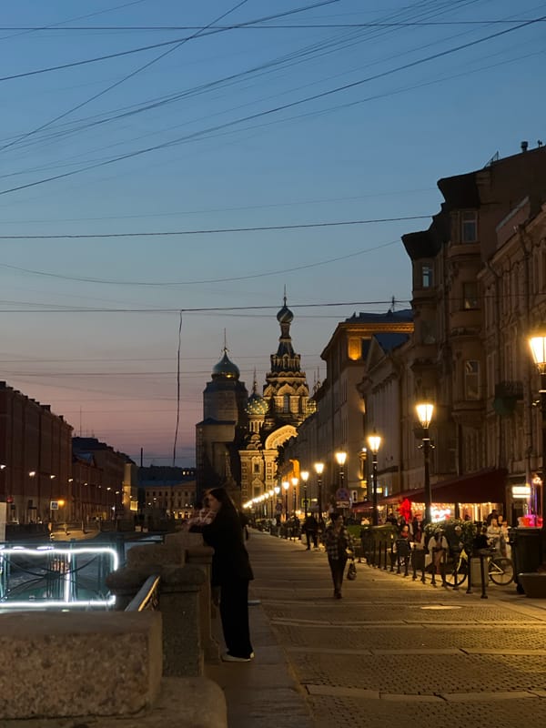 Leaning on a canal railing at twilight in Saint Petersburg