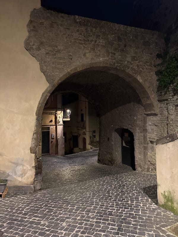 Nighttime scenes of historic cobblestone streets in Italian town