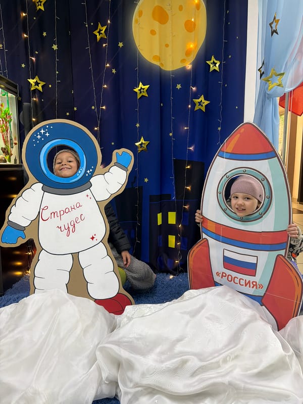 Children pose with space-themed cutouts in Krasnoyarsk