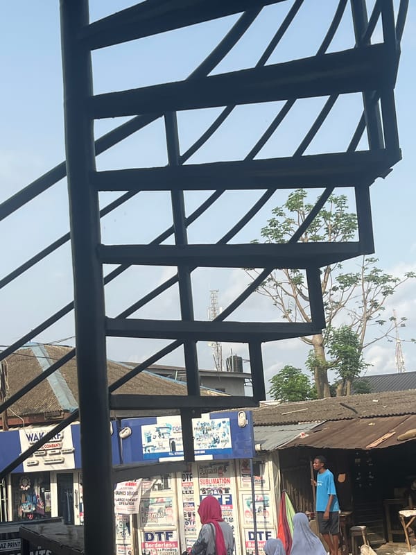 Street vendor carries food container in Lagos commercial district
