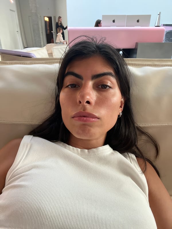 Young woman in white tank top documented resting indoors