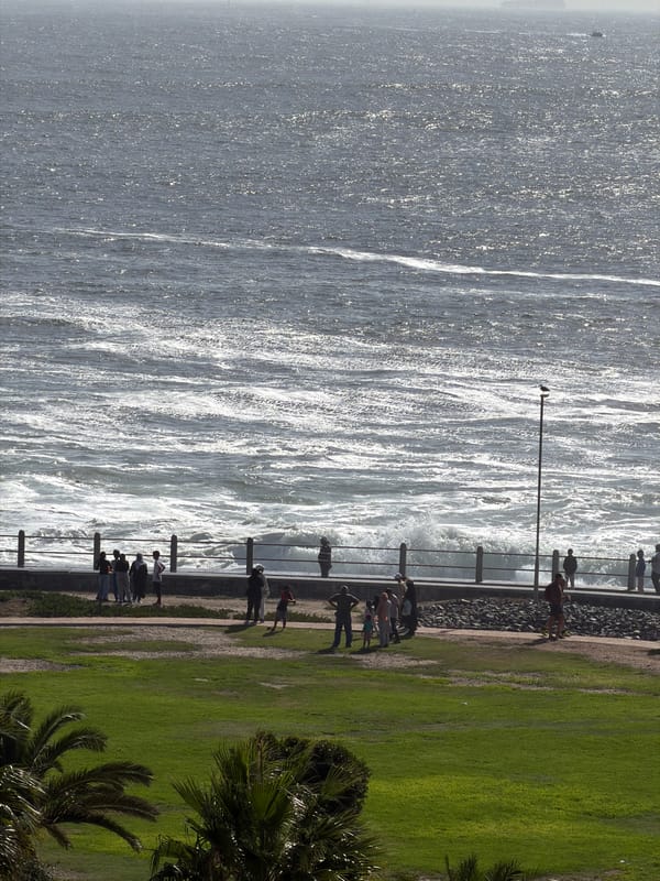 People gather at Sea Point Promenade overlooking choppy Atlantic