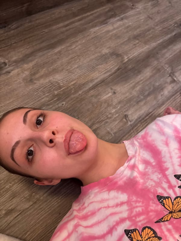 Young person takes playful floor selfies in Bulgaria