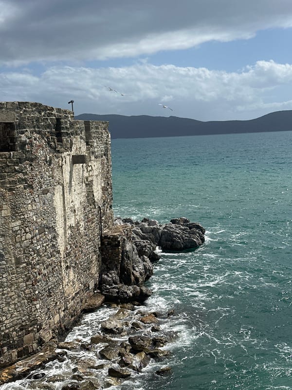 Weathered stone castle observed along Bodrum's turquoise coastline