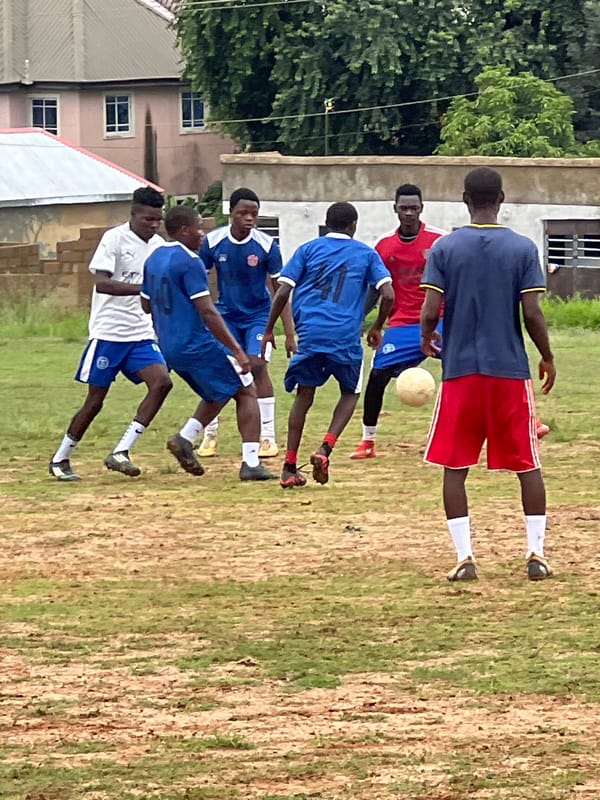 Pickup football on a Jos neighborhood field