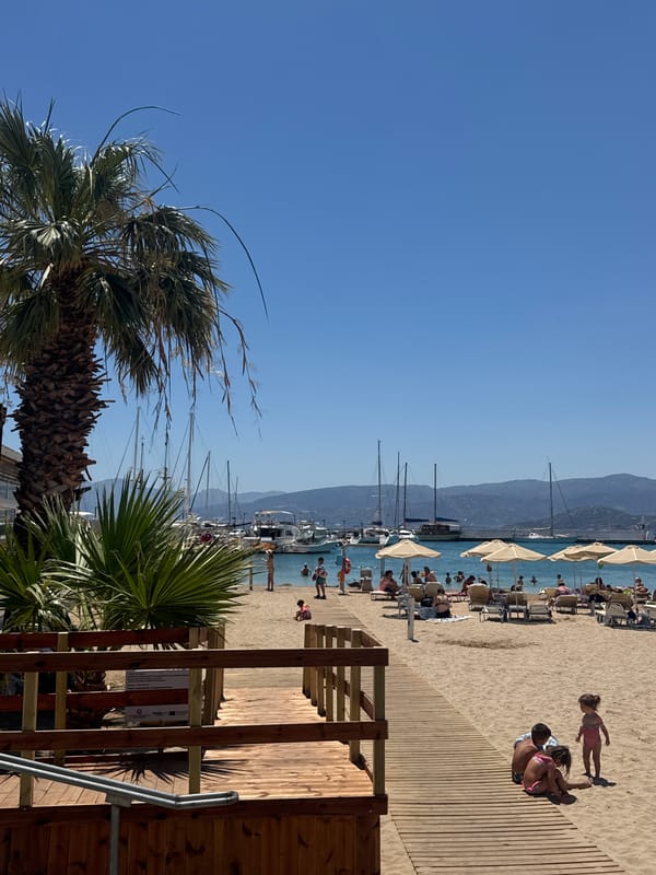Sunny morning around the harbor and beach of Agios Nikolaos