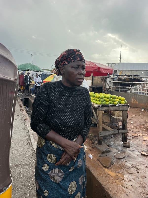 Busy outdoor market scene with vendors, produce, and street food