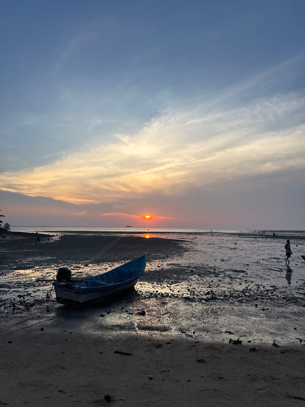 Sunset fishing boats documented at Thai coastal village