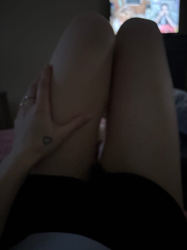 Cat napping, legs up, low light — a chill night in.
