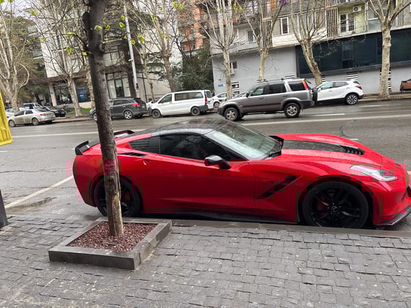 Red Corvette spotted parked on Tbilisi cobblestone street