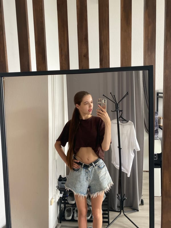 Quick selfie session in brown tee and denim shorts