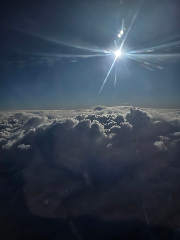 Aerial view captured over Kommunarka showing sunlight and clouds