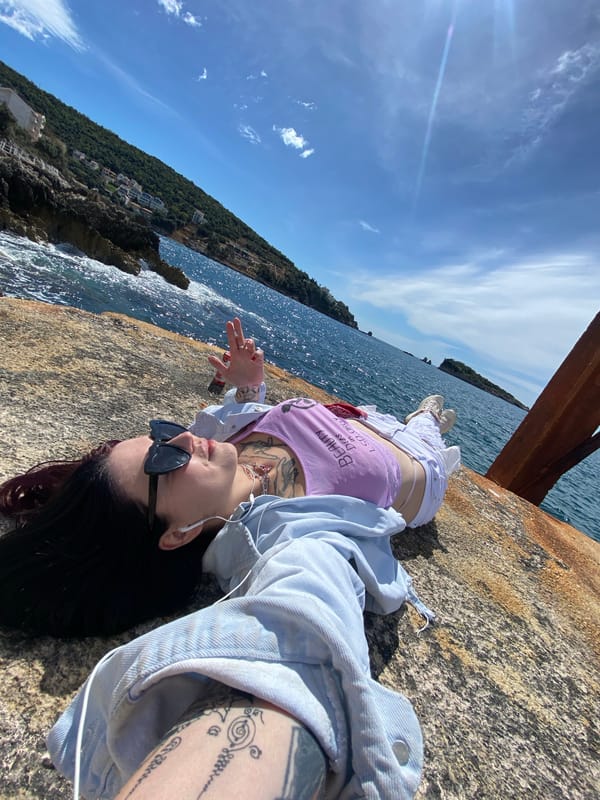 Person photographed at multiple coastal spots in Montenegro