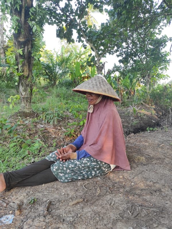 Elderly person rests in rural Indonesian countryside