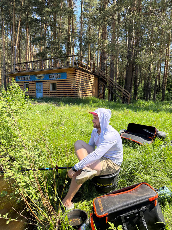 Fisherman catches fish during morning outing near Прикамский, Russia