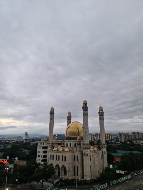 Almaty at dusk: the Central Mosque and city under heavy cloud