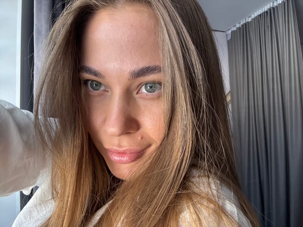 Woman walks leashed cat through Russian town streets