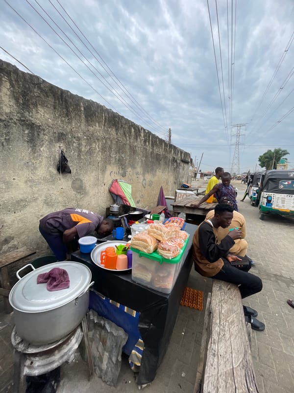 Morning street food vendors serve customers in Ado, Nigeria