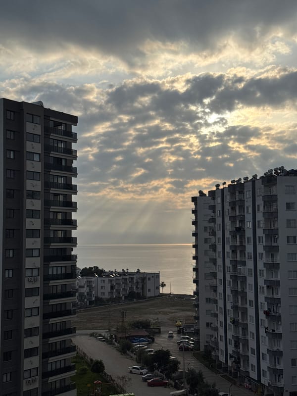 Dawn light breaks through clouds over Erdemli coastline
