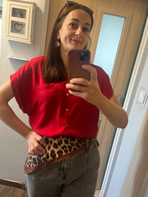 Mirror selfie in red shirt and leopard-print belt
