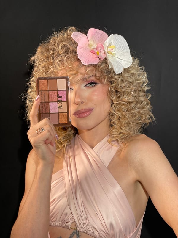 Woman poses with makeup palette in Vysokaya Gora