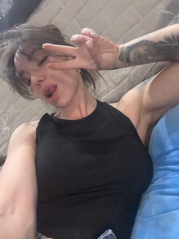 Person photographed resting indoors wearing dark clothing