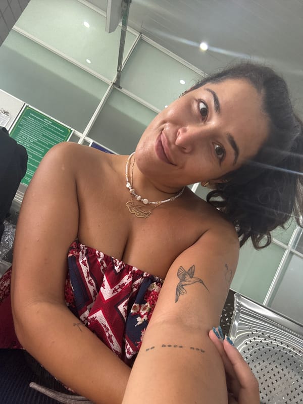 Indoor selfie in Ben Cau, patriotic-patterned top and pearls