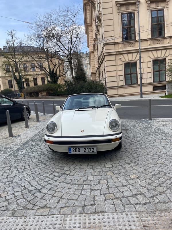 Vintage white Porsche spotted on cobblestone street in Brno