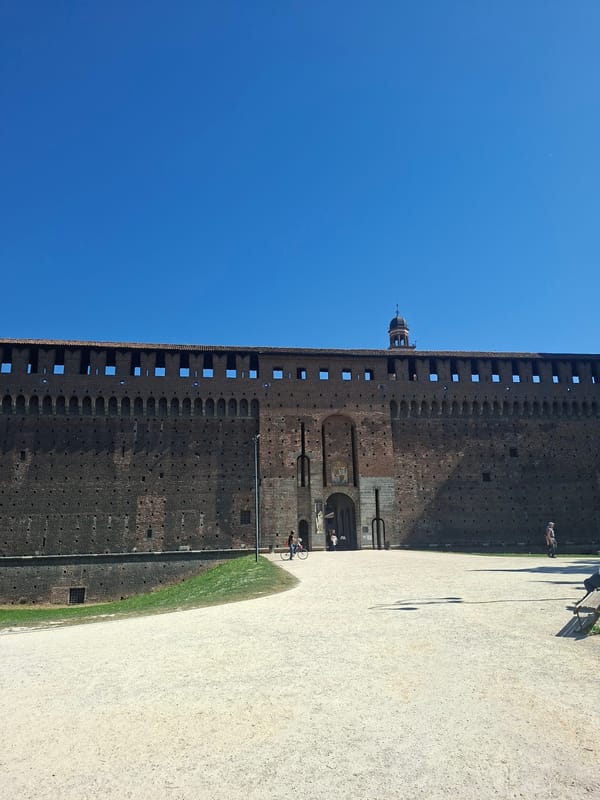 Tourists visit Milan's Sforza Castle on sunny April morning