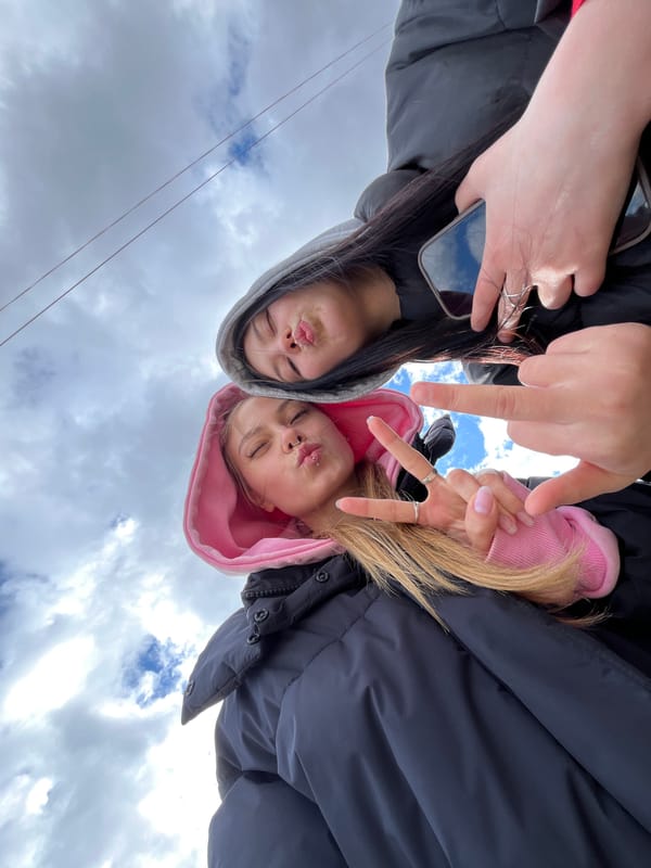 Friends take early morning selfies on bridge in Chaikovsky