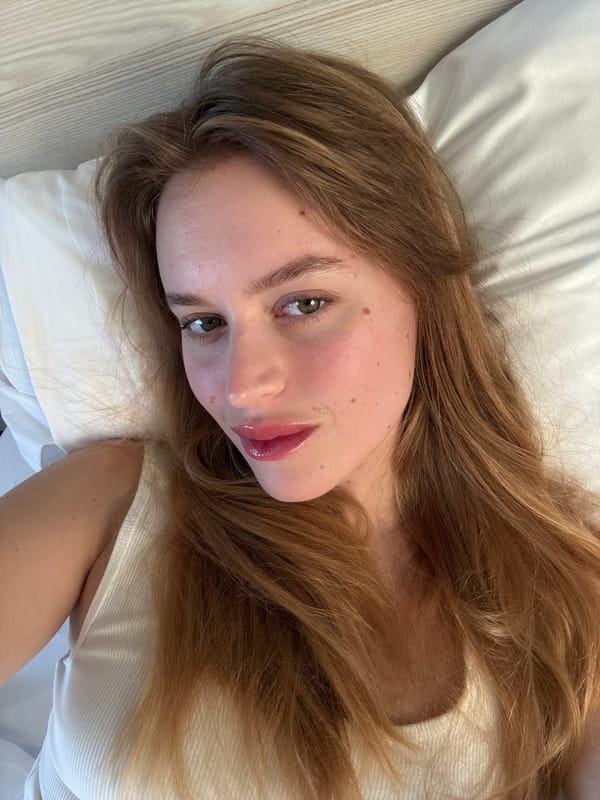 Woman rests on pillow in Nice bedroom