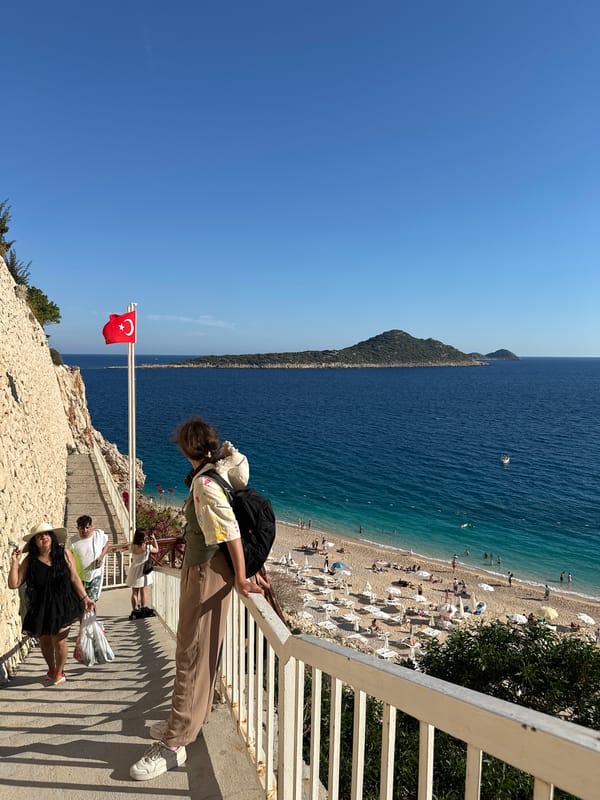 Tourists capture scenic Mediterranean coastline views in Kaş, Turkey