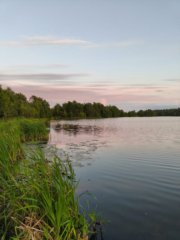 Dusk settles over a calm lake in Khittolovo, Russia