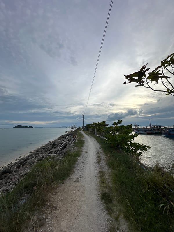 Morning stroll along Ko Pha-ngan's rocky harbor shoreline