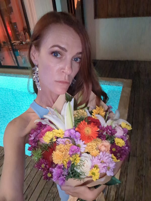 Woman with flower bouquet photographed by illuminated pool in Kediri