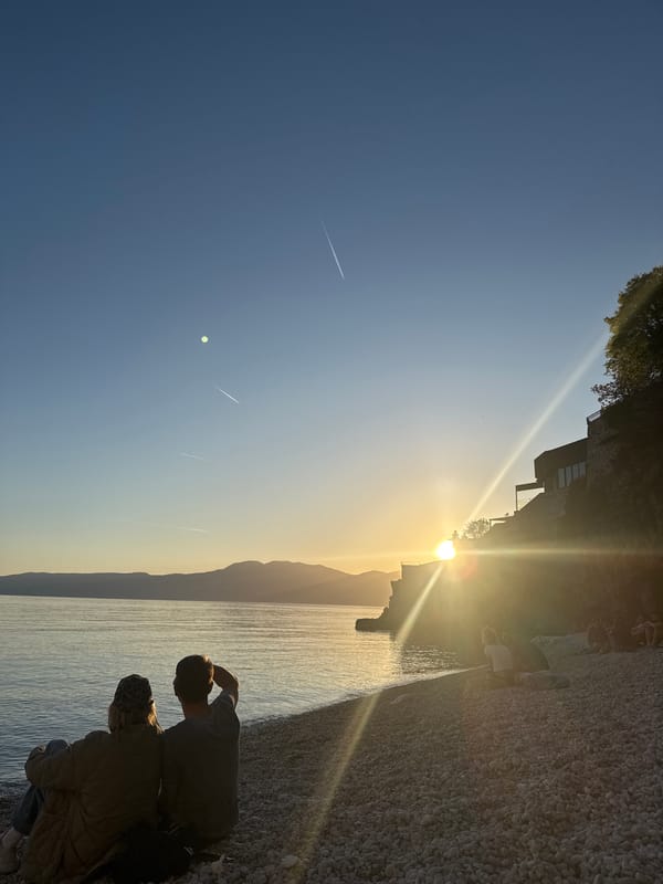 Two people enjoy sunset on Rijeka beach