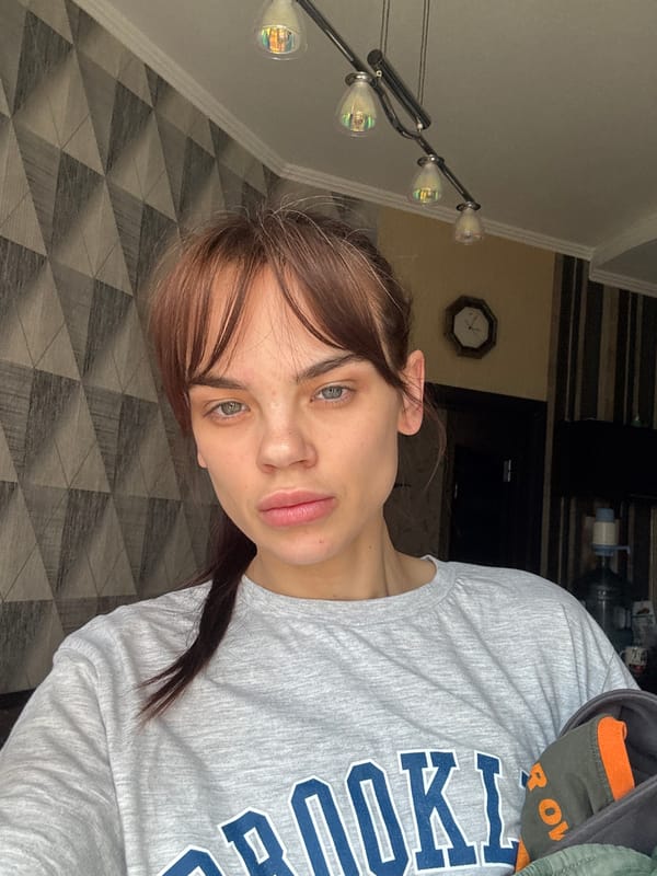 Woman in Brooklyn shirt photographed in Rostov-on-Don apartment