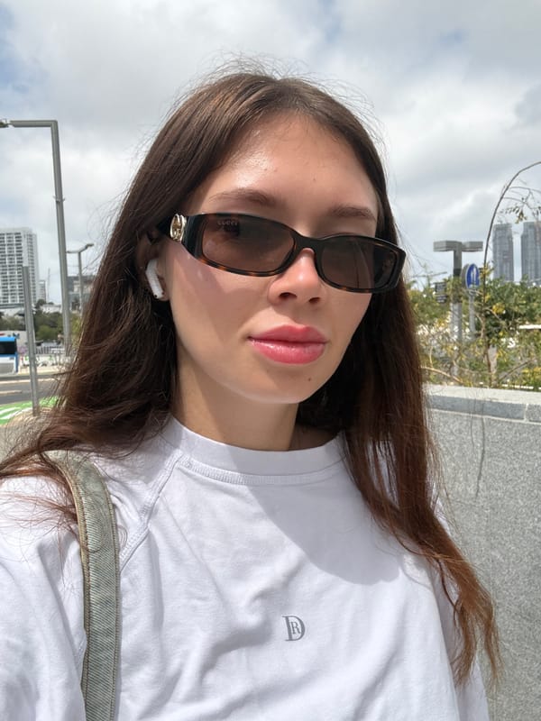 Woman takes selfie in designer accessories in Tel Aviv