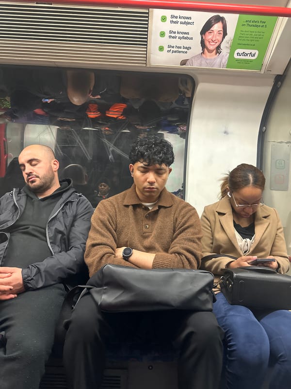 Morning commuters photographed aboard London Underground train