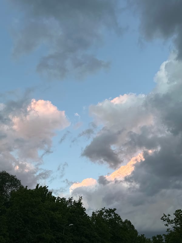 Evening sky with pink-tinted clouds observed in Riga