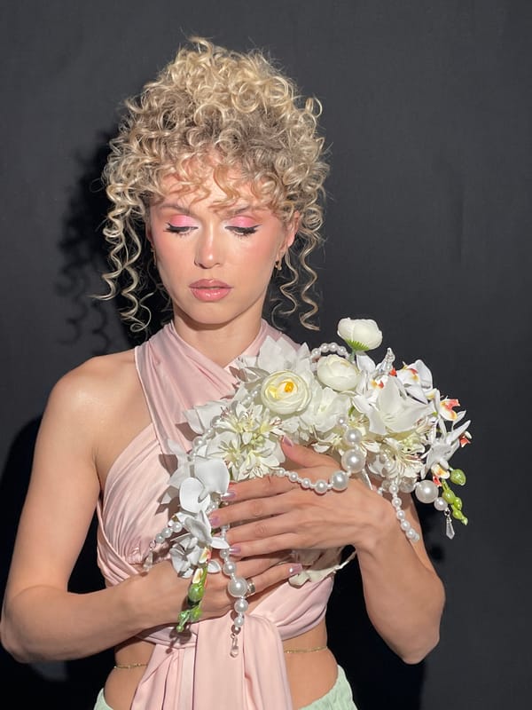 Woman in pink dress poses with flower bouquet in Kazan