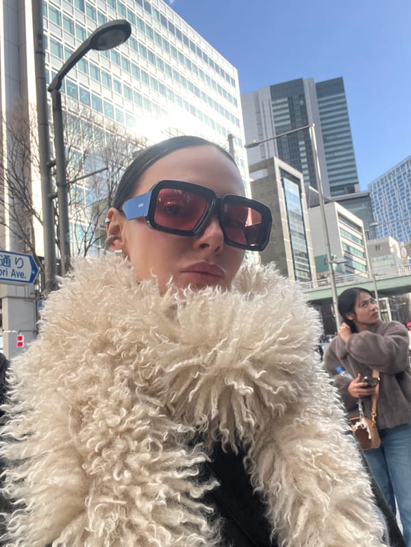 Woman takes selfie in early morning Shibuya near Miyashita Park